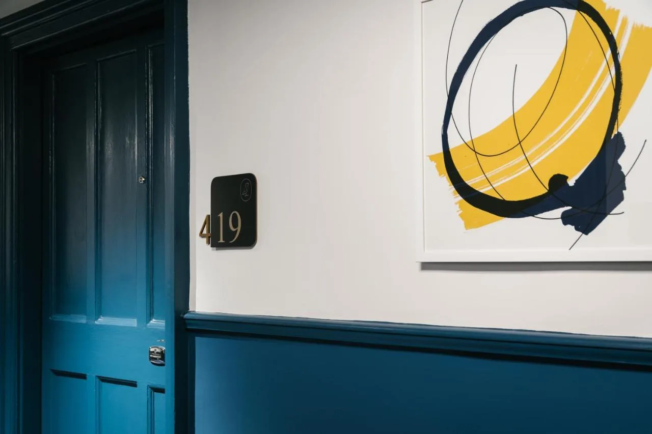 a room with a door and a picture of a basketball at voco Grand Central Glasgow by IHG in Glasgow