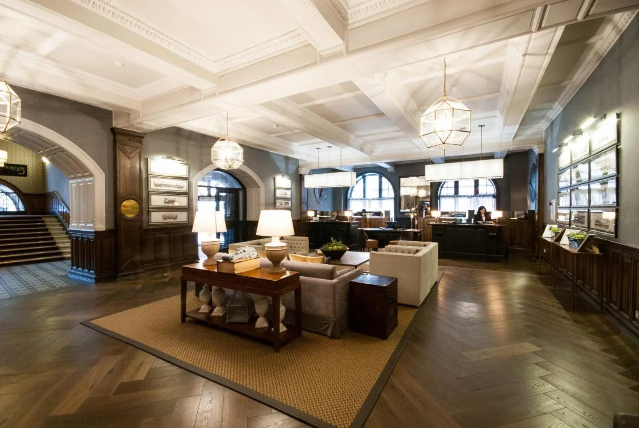 a lobby with a couch and a table in a building at voco Grand Central Glasgow by IHG in Glasgow